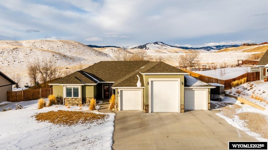 ranch-style house featuring a mountain view and a garage