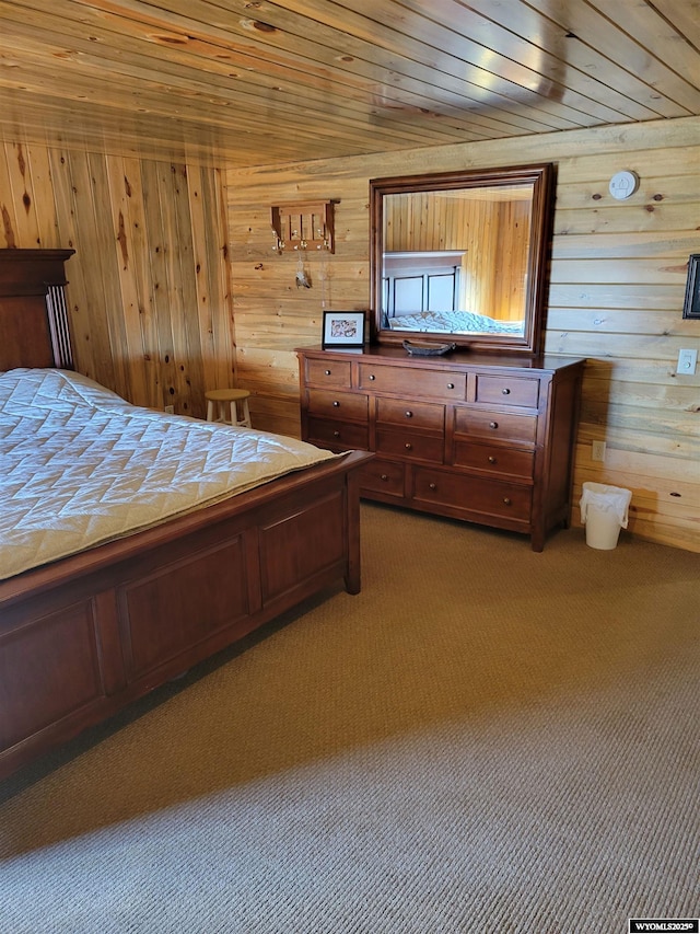 unfurnished bedroom with carpet flooring, wood walls, and wooden ceiling