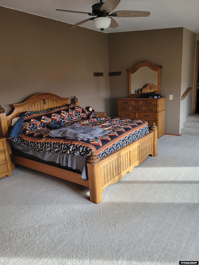 6447 Clark Cir, Torrington, WY 82240 - bedroom with light colored carpet and a ceiling fan