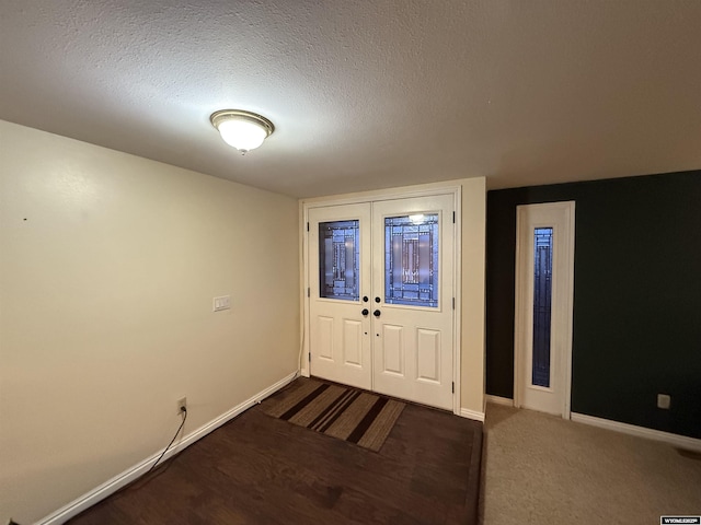 foyer entrance with a textured ceiling