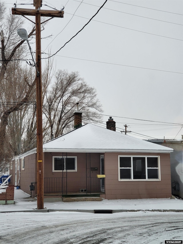 view of front of house featuring a chimney