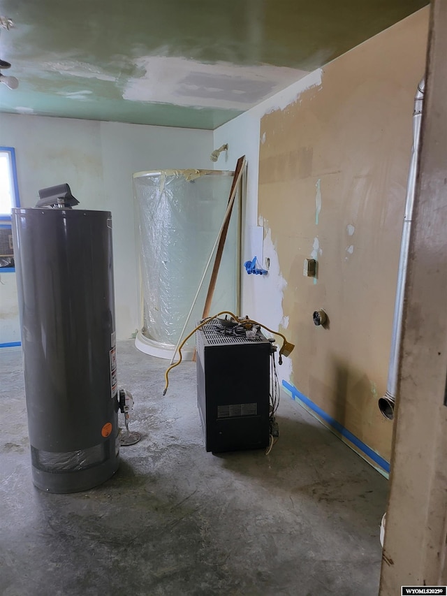 interior space featuring water heater and concrete flooring