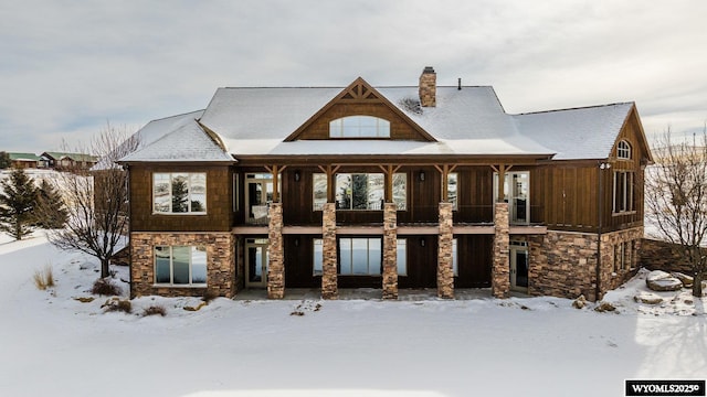 view of snow covered rear of property