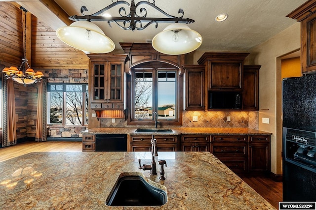 kitchen with pendant lighting, sink, and black appliances