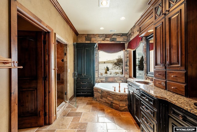 bathroom with ornamental molding, vanity, and independent shower and bath