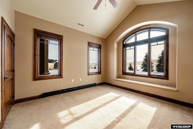 carpeted spare room featuring vaulted ceiling, ceiling fan, and a baseboard heating unit