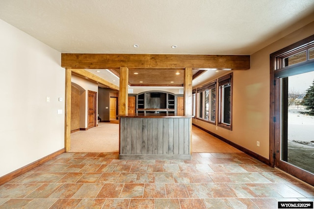 kitchen with beam ceiling and a textured ceiling