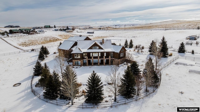 snowy aerial view featuring a mountain view