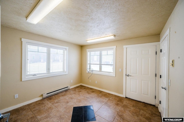 entryway with a textured ceiling and a baseboard heating unit