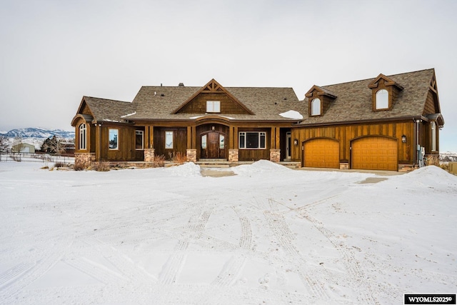 view of front facade featuring a mountain view and a garage