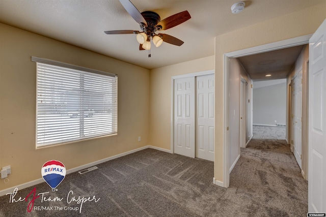 unfurnished bedroom featuring carpet, a closet, and ceiling fan