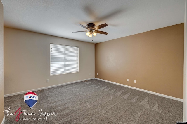 spare room featuring carpet and ceiling fan