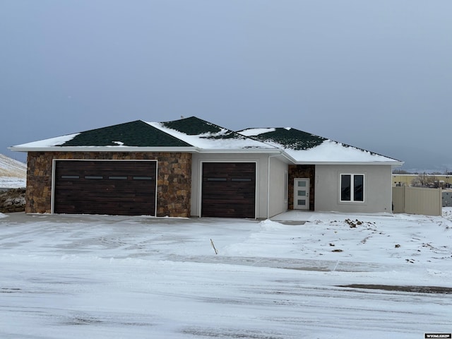 view of front facade with fence and an attached garage