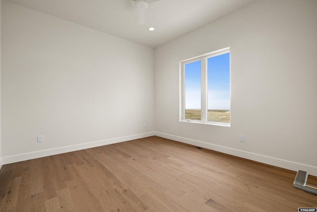 unfurnished room with ceiling fan, baseboards, wood finished floors, and recessed lighting