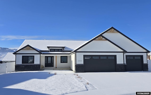 view of front of home featuring a garage and fence