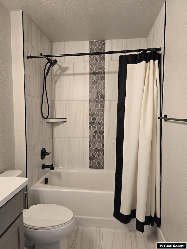 bathroom featuring a textured wall, toilet, shower / tub combo with curtain, a textured ceiling, and vanity