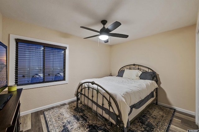 bedroom with hardwood / wood-style floors and ceiling fan