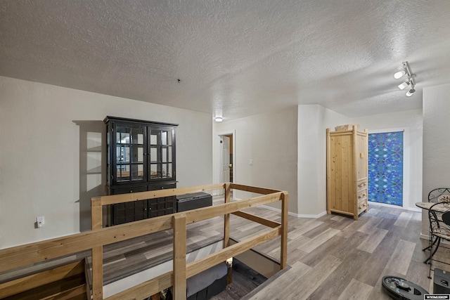 dining space with hardwood / wood-style flooring and a textured ceiling