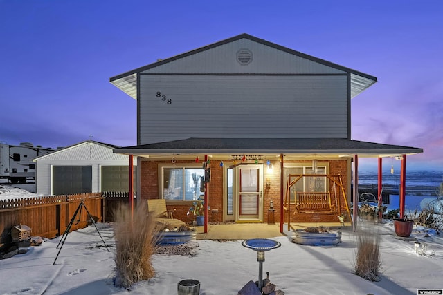 view of snow covered rear of property