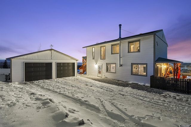 exterior space with a garage and an outdoor structure