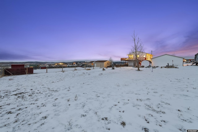 snowy yard with a wooden deck