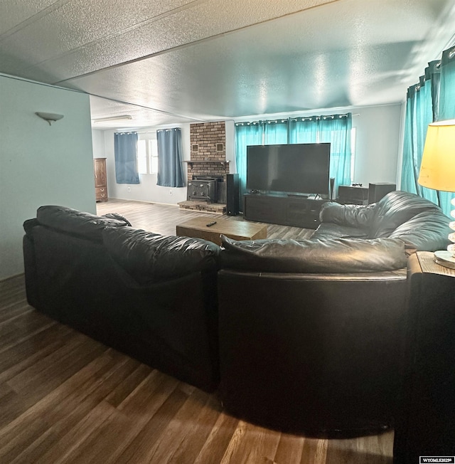 living room with a textured ceiling and hardwood / wood-style floors