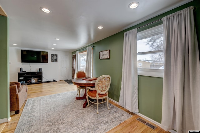 dining room with hardwood / wood-style flooring and plenty of natural light