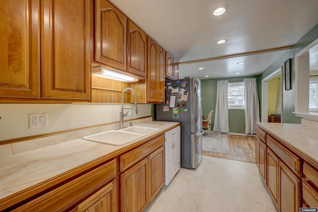 kitchen featuring stainless steel refrigerator, sink, and dishwasher