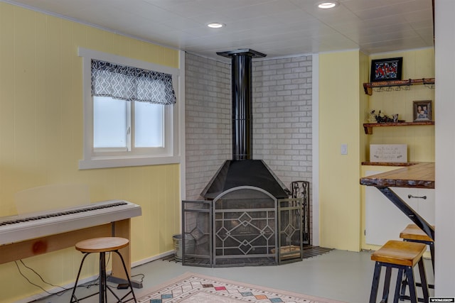 interior space featuring a wood stove and concrete flooring