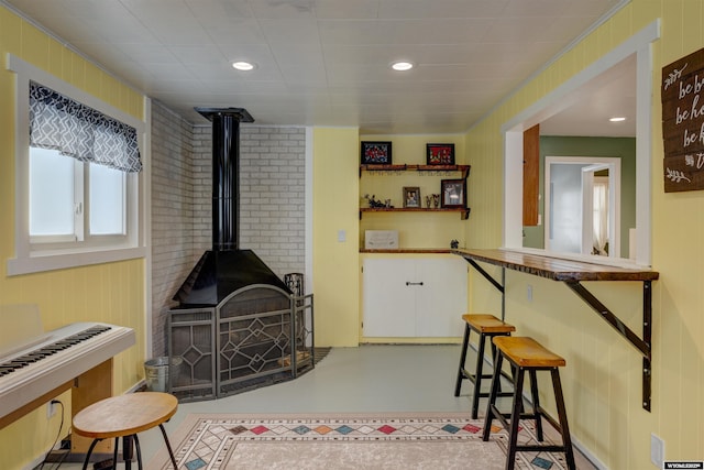 rec room with a wood stove