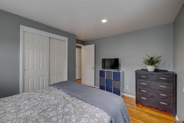 bedroom featuring light wood-type flooring and a closet