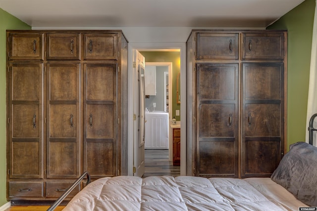 bedroom with light hardwood / wood-style flooring and a closet