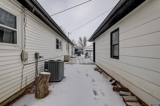 view of snowy exterior featuring cooling unit