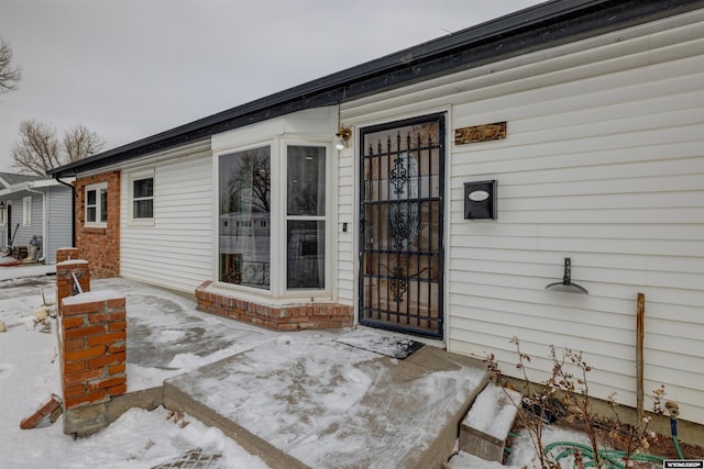 view of snow covered property entrance