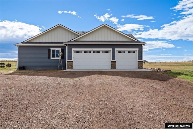 craftsman-style house with an attached garage, stone siding, dirt driveway, and board and batten siding