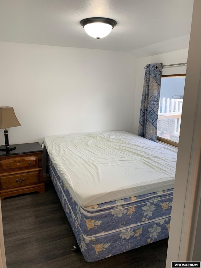 bedroom featuring dark wood-style flooring