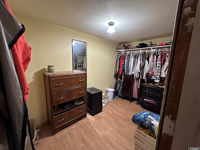 walk in closet with light wood-type flooring