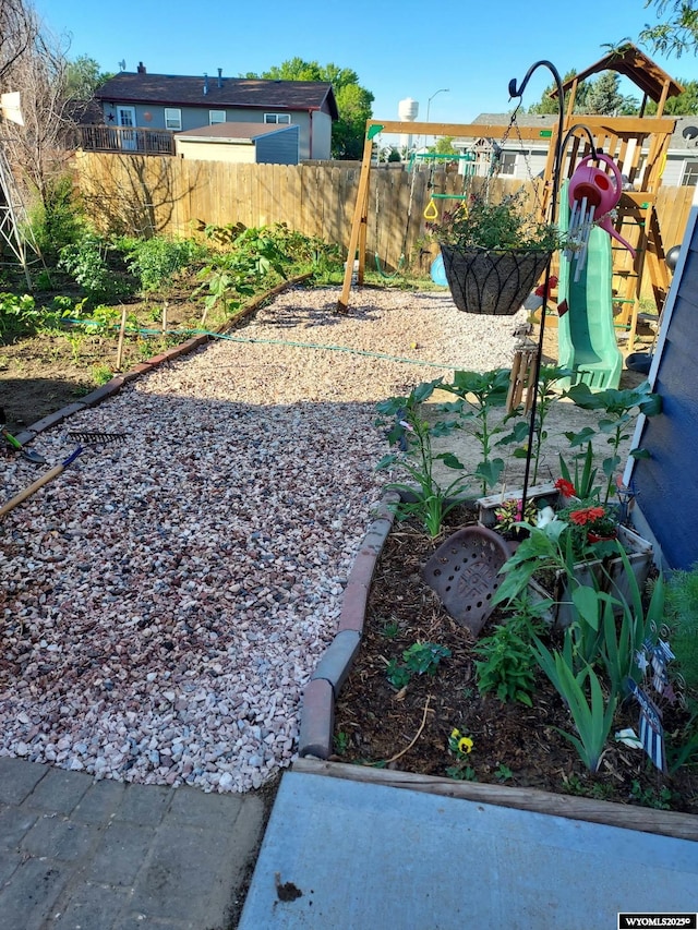 view of yard featuring fence and a playground