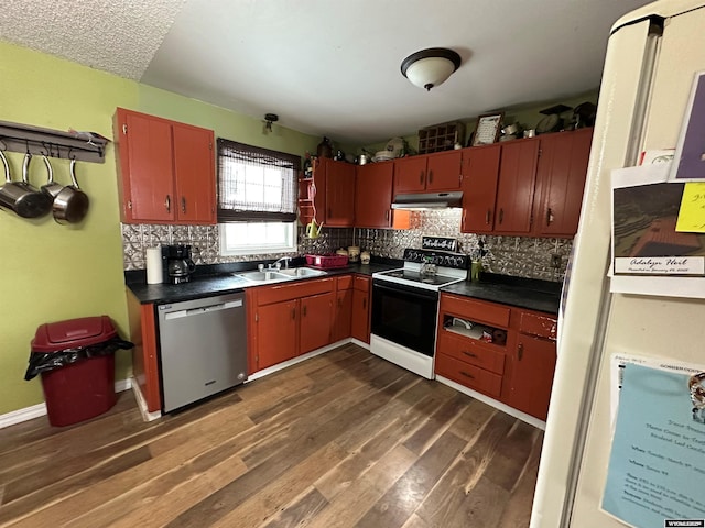 kitchen with under cabinet range hood, electric range, a sink, stainless steel dishwasher, and dark countertops