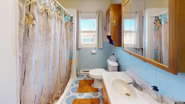 full bath featuring a baseboard radiator, toilet, vanity, tile walls, and a shower with curtain