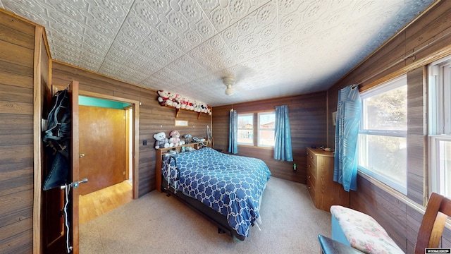 bedroom with carpet flooring and wooden walls