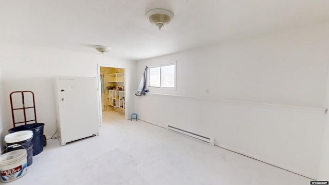 interior space with concrete flooring and a baseboard radiator