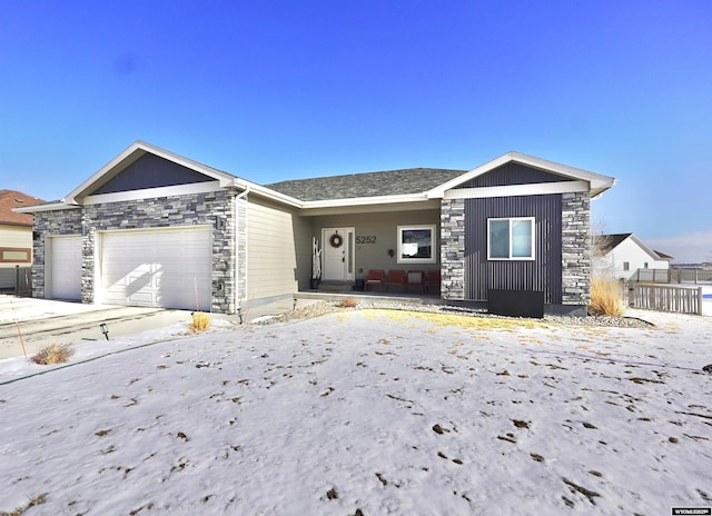 ranch-style home with stone siding and an attached garage