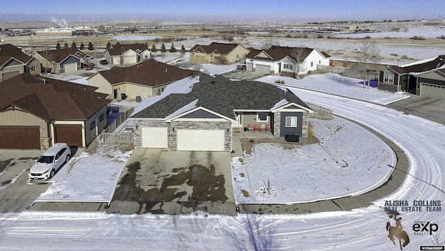 snowy aerial view featuring a residential view