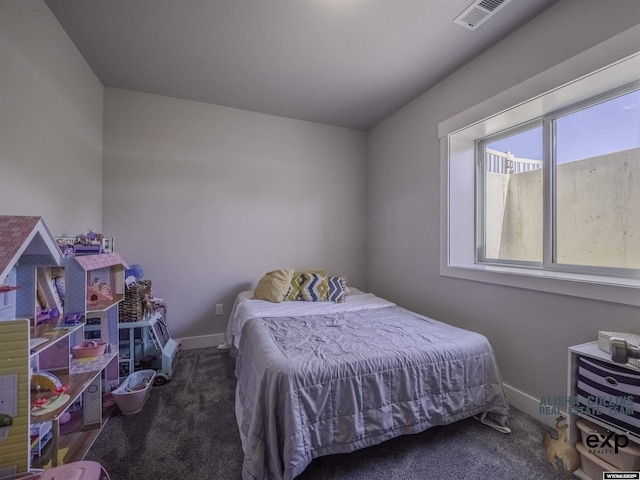 carpeted bedroom with visible vents and baseboards