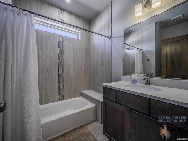 full bath featuring vanity, shower / bath combo with shower curtain, and visible vents