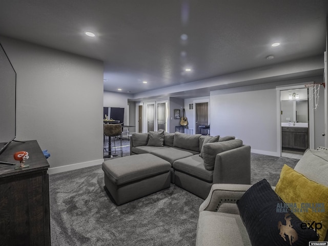 living area with recessed lighting, dark carpet, and baseboards