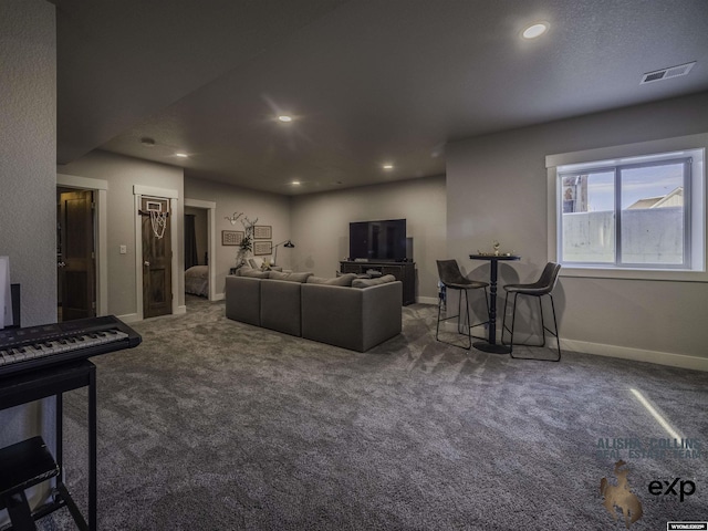 living room with recessed lighting, visible vents, dark carpet, and baseboards