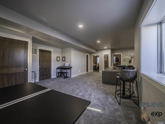 carpeted living room featuring baseboards and recessed lighting