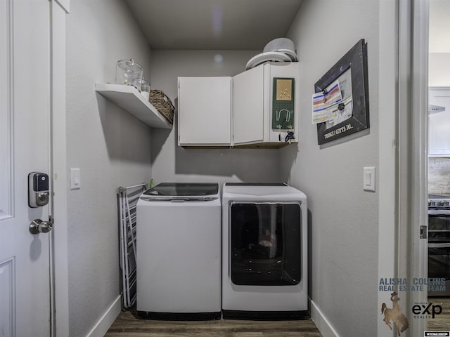 clothes washing area featuring separate washer and dryer, dark wood finished floors, cabinet space, and baseboards